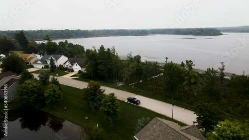 Suburban neighborhood situated on a calm but cloudy lake. photo