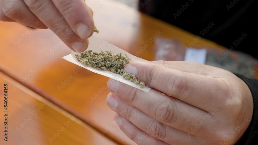 Rolling joint, mans hands, marijuana joint, cannabis, weed, cannabis. 4K 24FPS.