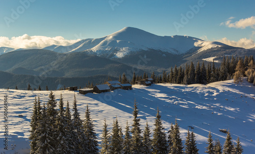 Beautiful winter landscape. Frosty morning on the farm. Carpathian mountains, Ukraine, Europe. Christmas holiday concept. Perfect winter wallpaper.