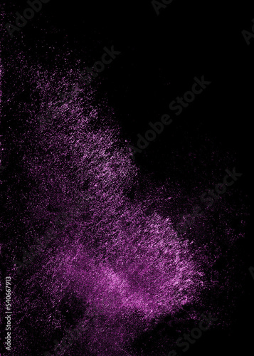 Purple sequins glisten with dust isolated on a black background. Vertical abstract background with sparkling dust