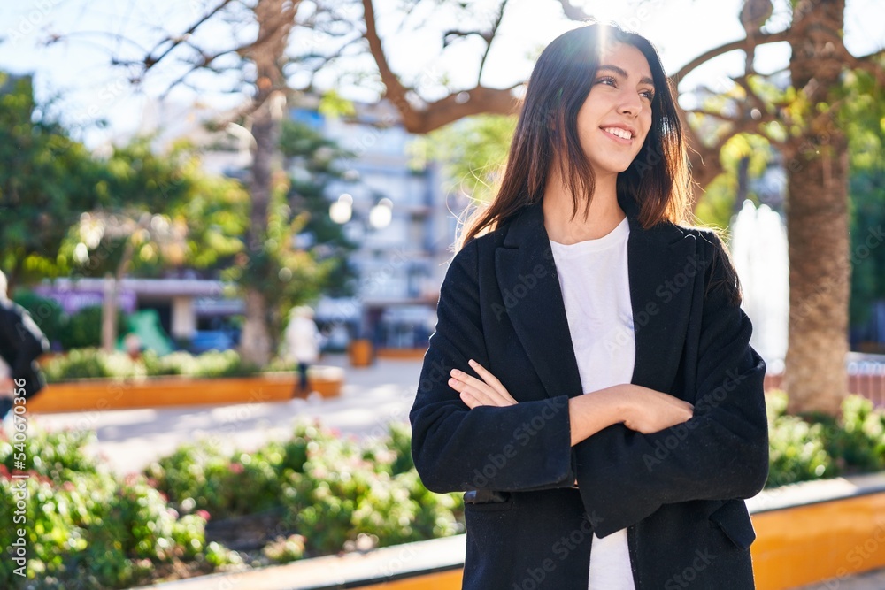 Young beautiful hispanic woman standing with arms crossed gesture at park Young beautiful hispanic woman standing with arms crossed gesture at park