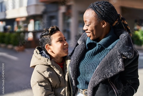 African american mother and son smiling confident hugging each other at street