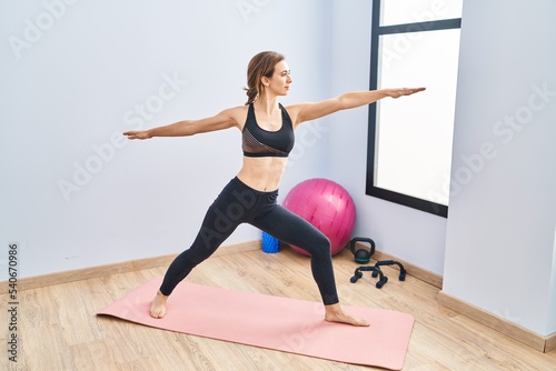 Young woman training yoga at sport center