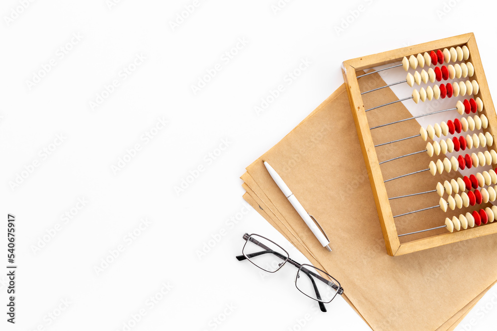 Old accounting wooden abacus with blank sheet of paper Old accounting wooden abacus with blank sheet of paper