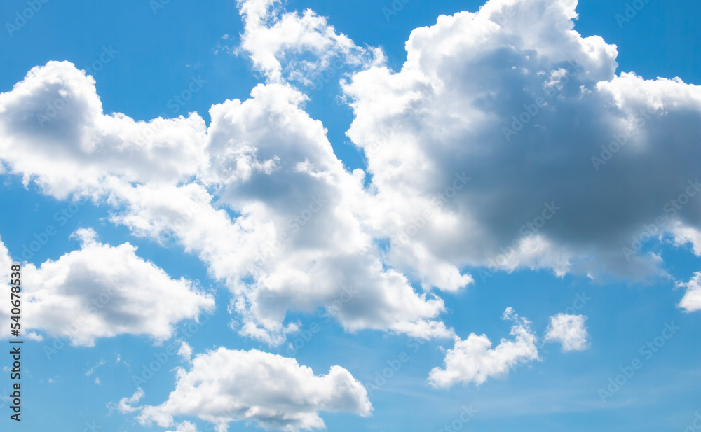 Obraz premium Summer blue sky with cumulus clouds, Heated air rises due to convection and forms cumulus clouds