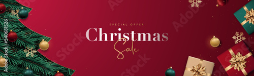 Christmas sale banner. Realistic Christmas tree branches with balls, snowflakes and gift boxes. Winter holidays discounts.
