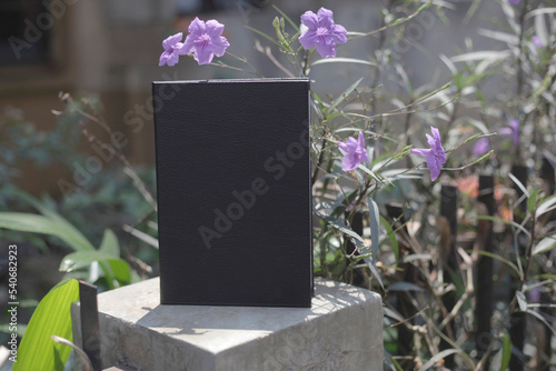 Cool and mysterious black book notes in leather cover photo