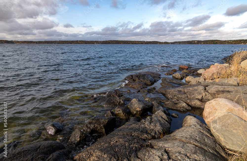 Rocky shore of the sea bay under the blue sky on an autumn day Rocky shore of the sea bay under the blue sky on an autumn day