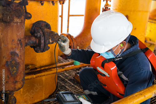 Inspectors inspect pipes severe corrosion the petrochemical industry oil and gas with ultrasonic instruments. photo