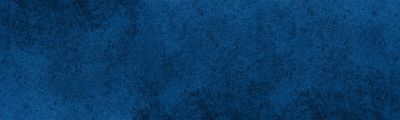 Navy blue textured surface. Indigo color rough panoramic texture. Dark dramatic abstract background