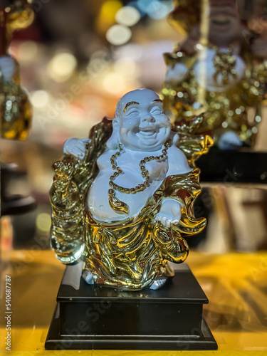 White and gold statue of lucky baba photo