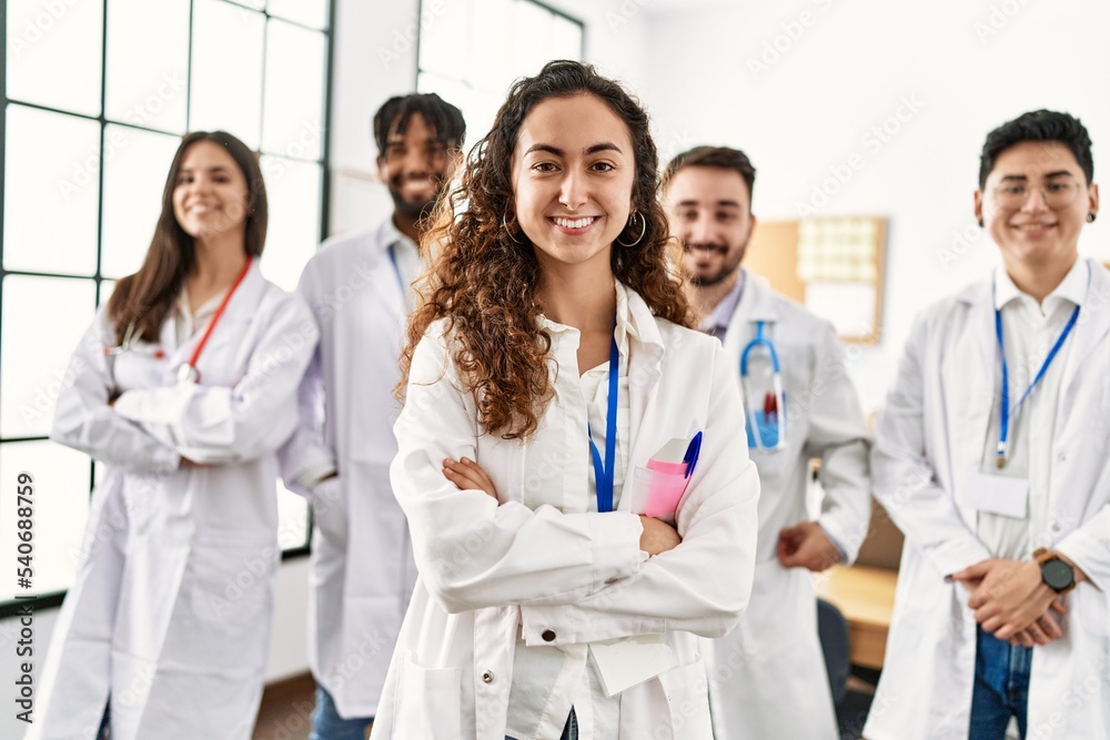Group of young doctor smiling happy standing with arms crossed gesture at the clinic office. Group of young doctor smiling happy standing with arms crossed gesture at the clinic office.