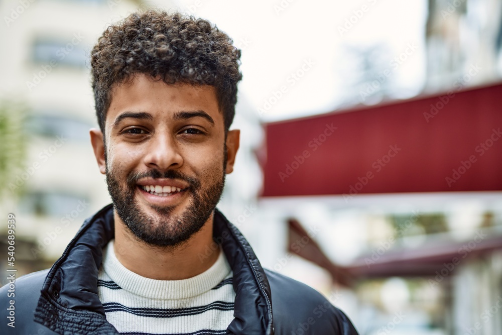 Young arab man smiling outdoor at the town Young arab man smiling outdoor at the town