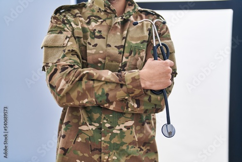 Young arab man army soldier holding stethoscope at clinic