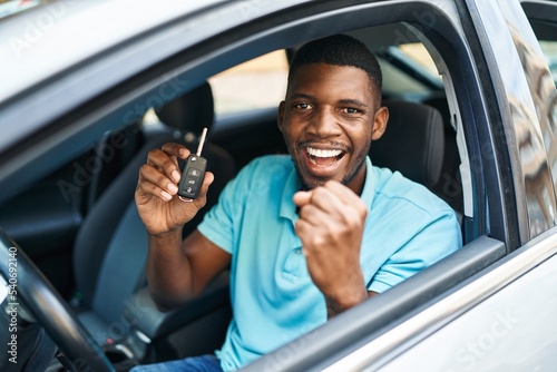 Photography Young african american man holding key of new car with cheerful expression at st