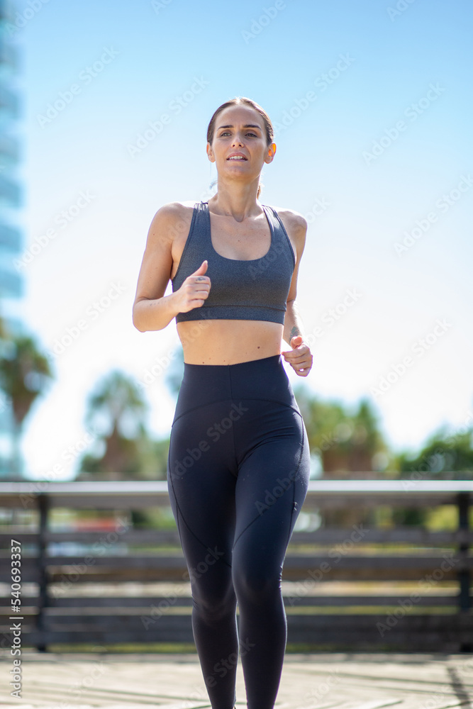 young woman running outdoors in city