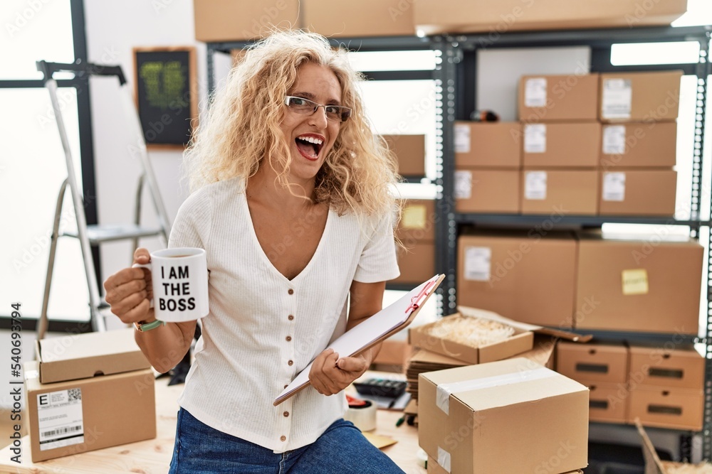 Middle age blonde woman working at small business drinking coffee cup celebrating crazy and amazed for success with open eyes screaming excited. Middle age blonde woman working at small business drinking coffee cup celebrating crazy and amazed for success with open eyes screaming excited.