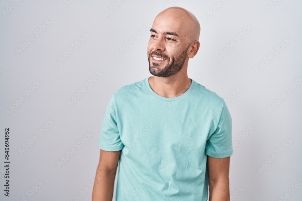 Middle age bald man standing over white background looking away to side  with smile on face, natural expression. laughing confident. Stock Photo |  Adobe Stock