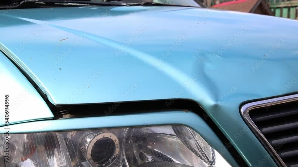 Broken car with dents on the body after an accident. Transport insurance, close-up