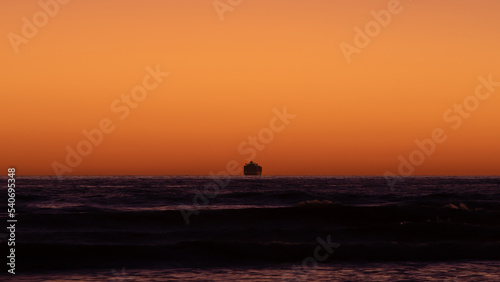 Silhouette of cruise ship on the horizon.