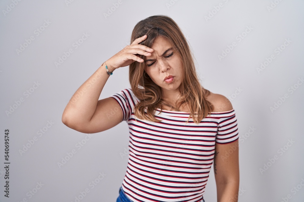 Young hispanic woman standing over isolated background worried and stressed about a problem with hand on forehead, nervous and anxious for crisis Young hispanic woman standing over isolated background worried and stressed about a problem with hand on forehead, nervous and anxious for crisis