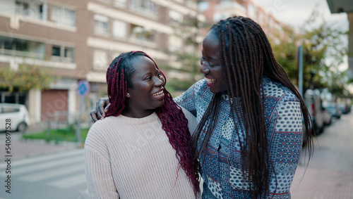 Two african american friends smiling confident hugging each other standing at street © Krakenimages.com