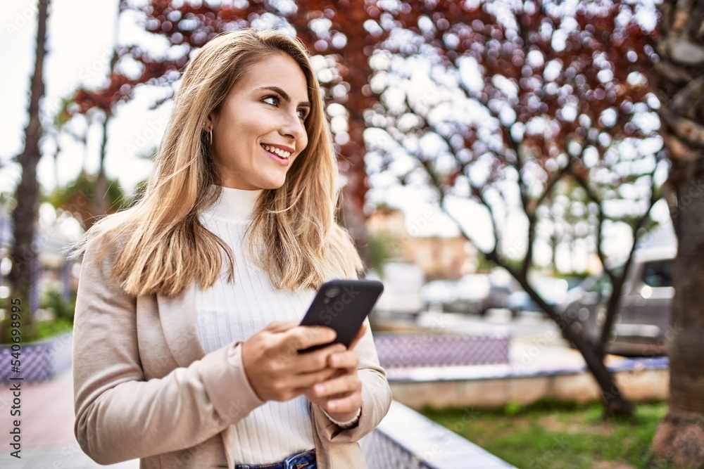 Young blonde woman smiling confident using smartphone at park Young blonde woman smiling confident using smartphone at park