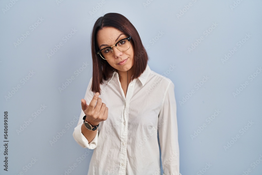 Young hispanic woman standing over white background beckoning come here gesture with hand inviting welcoming happy and smiling Young hispanic woman standing over white background beckoning come here gesture with hand inviting welcoming happy and smiling