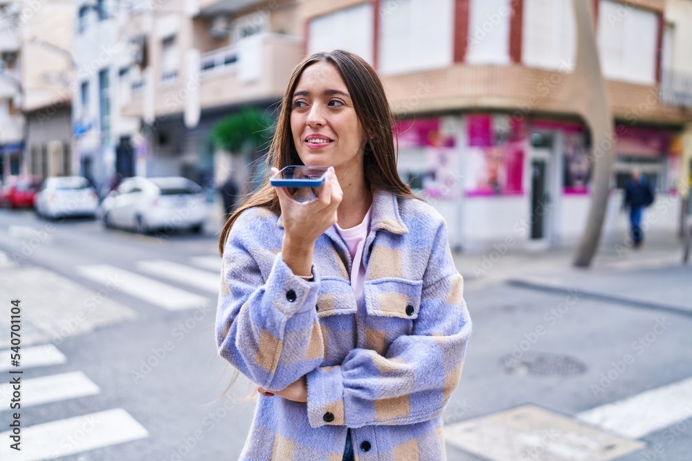 Young beautiful hispanic woman smiling confident talking on the smartphone at street Young beautiful hispanic woman smiling confident talking on the smartphone at street