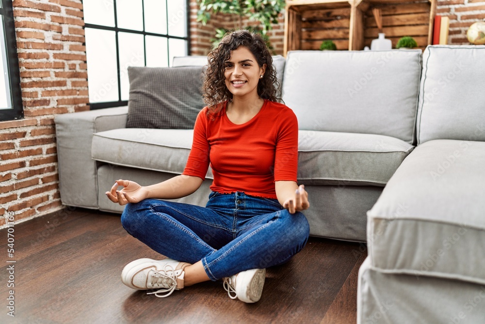 Young latin woman smiling confident doing yoga exercise at home Young latin woman smiling confident doing yoga exercise at home