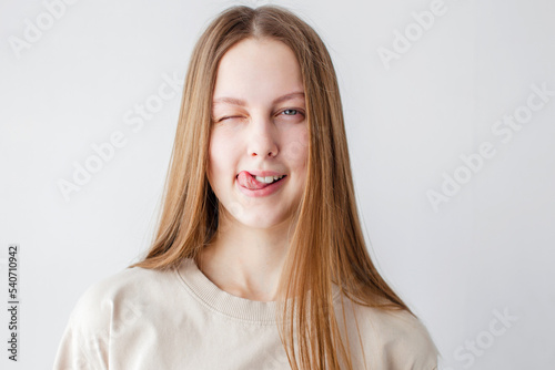 Portrait of young beautiful cute cheerful girl smiling over white background