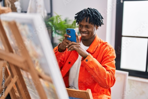 African american man artist smiling confident make picture by smartphone to draw at art studio