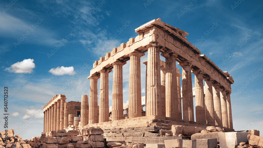 Naklejka premium Parthenon temple in Acropolis in Athens, Greece. Panoramic image on a bright sunny day, blue sky with clouds.