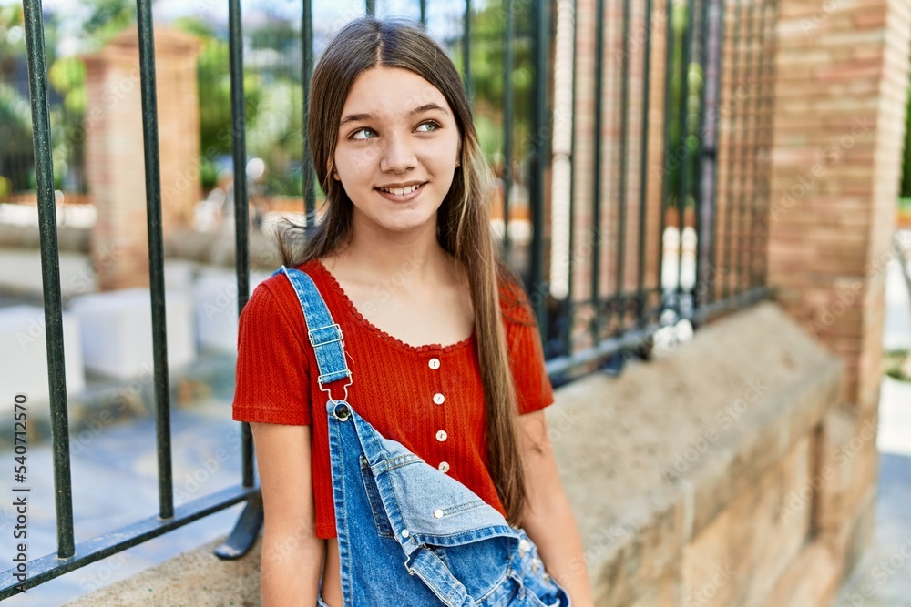 Caucasian teenager girl smiling happy standing at the city.