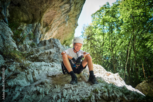 Happy boy with helmet on rock formation photo