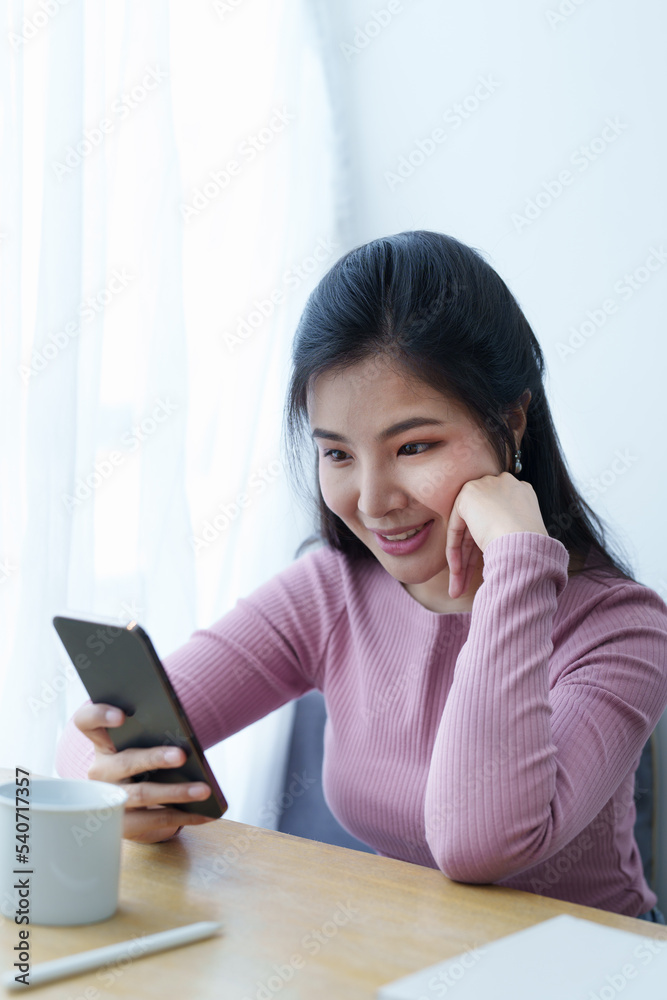 Portrait of a beautiful Asian teenage girl using a smartphone mobile Portrait of a beautiful Asian teenage girl using a smartphone mobile