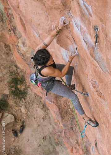 Fit rock climber trying hard on small holds