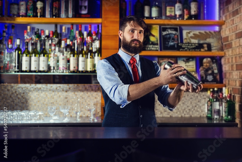Barman shaking cocktails in bar