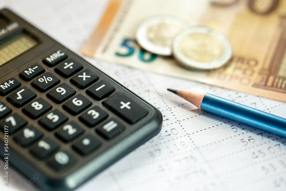 Calculator, money and pencil close-up on a blurred background. Calculator, money and pencil close-up on a blurred background.
