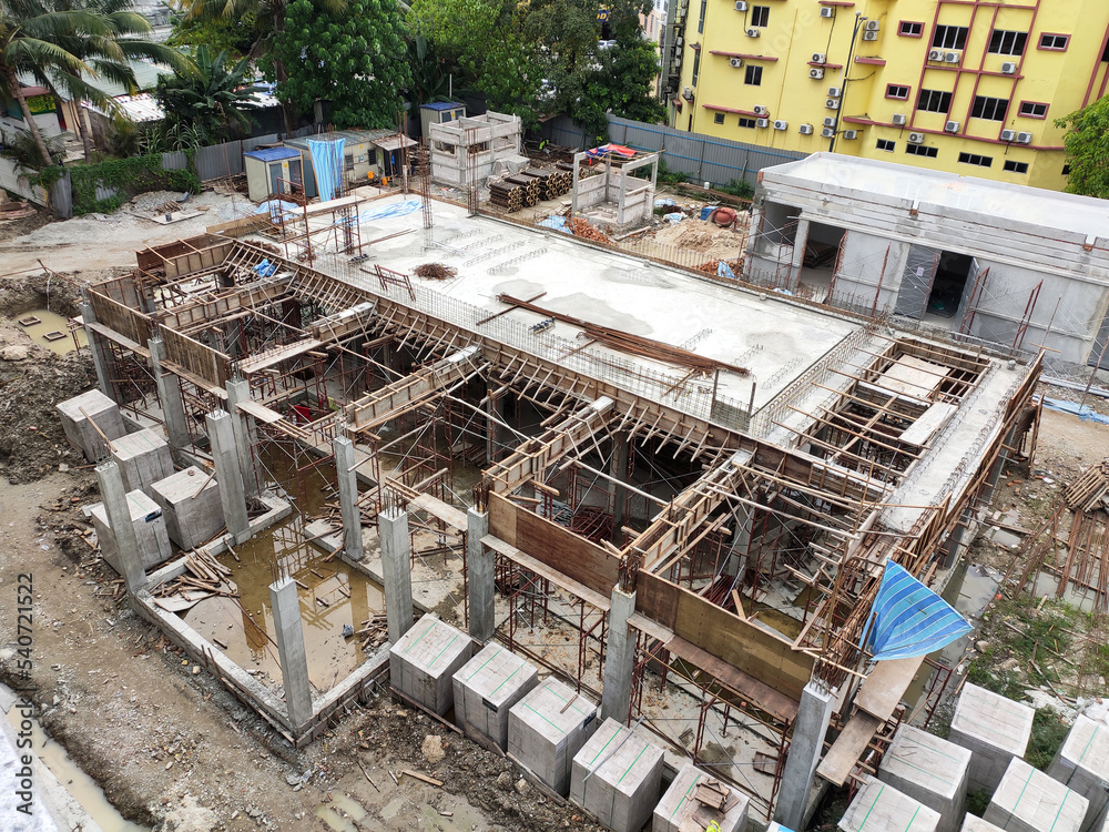 
JOHOR, MALAYSIA -JUNE 17, 2022: The construction site is in progress. Construction work is being carried out in stages. Construction workers are carrying out work under strict safety supervision.