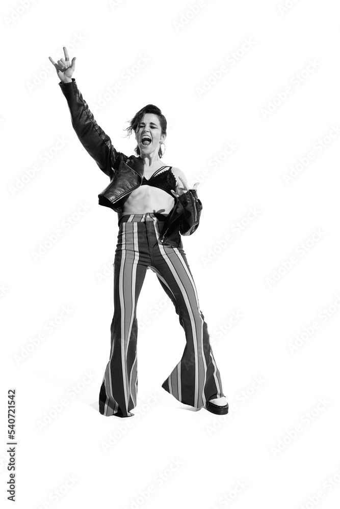 Portrait of beautiful young woman, rock music lover posing, dancing isolated over white background. Black and white photo Portrait of beautiful young woman, rock music lover posing, dancing isolated over white background. Black and white photo