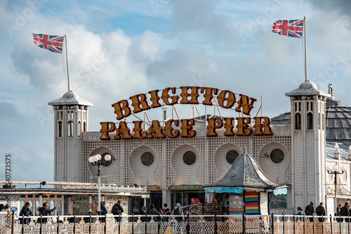 Brighton Palace Pier, with the seafront behind. View of the stunning city of Brighton and Hove with seagulls flying around at sunset. photo