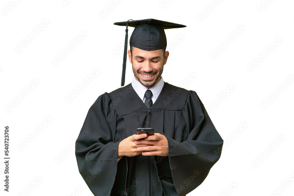 Young university graduate man over isolated background sending a message with the mobile Young university graduate man over isolated background sending a message with the mobile
