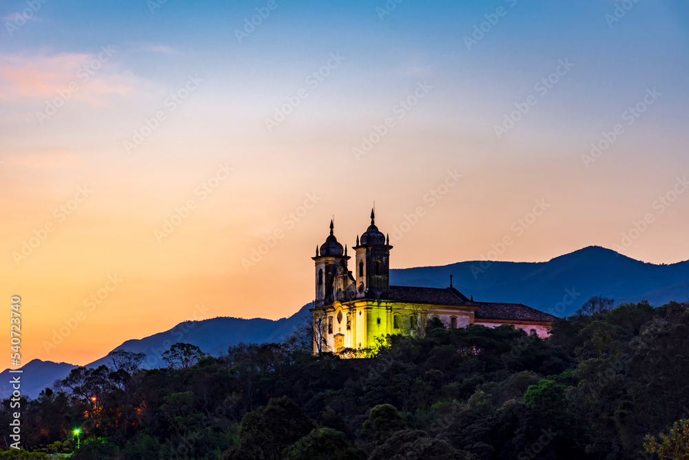 Historic church in baroque style on top of the mountain in Ouro Preto city in Minas Gerais during sunset