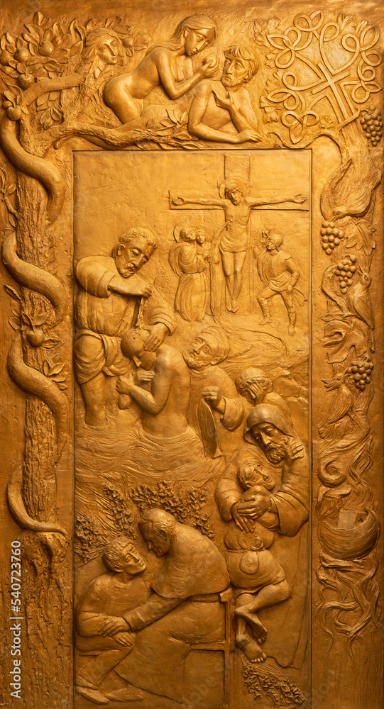 FORLÍ, ITALY - NOVEMBER 11, 2021: The bronze gate of the church Chiesa di San Giovanni Battista di Coriano with the biblical symbolic by Franco Vignazia and Elena Ortica (2014).