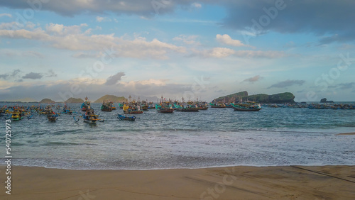 Fototapeta Naklejka Na Ścianę i Meble -  Fishing Boats at the white sand Papuma Beach in East Java, Indonesia