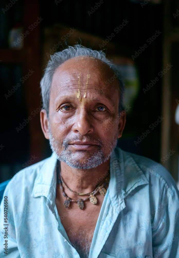 portrait of a senior person wearing tilak in forehead and garland of tulsi in neck portrait of a senior person wearing tilak in forehead and garland of tulsi in neck