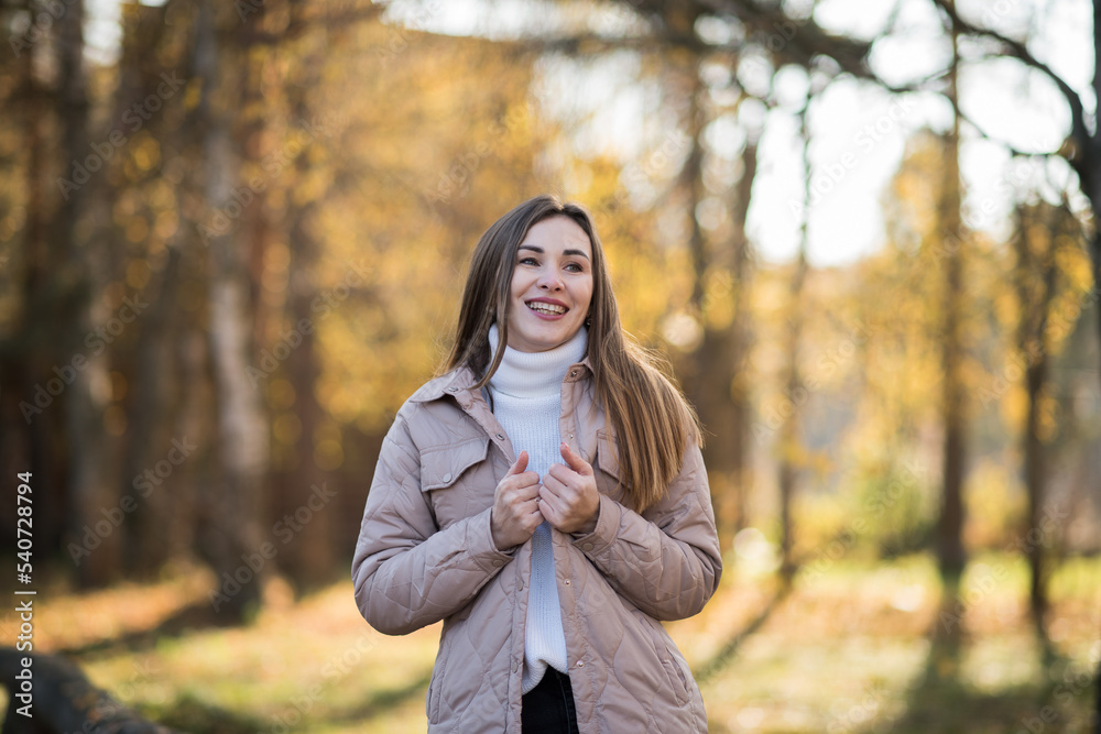 brunette in a grey jacket on the background of autumn nature. Young woman in a gray jacket, Portrait of a woman in autumn, warm autumn concept brunette in a grey jacket on the background of autumn nature. Young woman in a gray jacket, Portrait of a woman in autumn, warm autumn concept