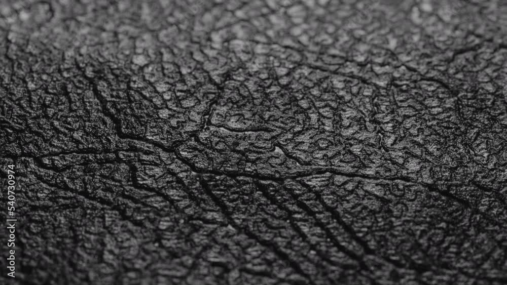 Black leather texture. Black leather texture close up. Extreme close up sliding camera footage. Black leather texture. Black leather texture close up. Extreme close up sliding camera footage.