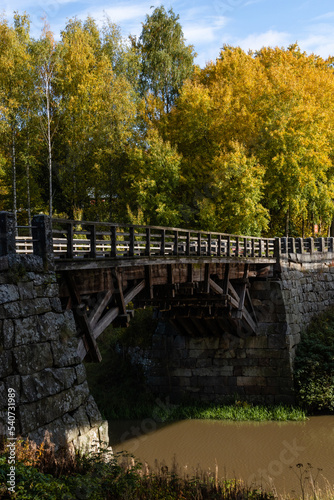 Halikko Old Bridge, built in 1866. Historic museum bridge in Salo, Finland with trees in autumn colors photo